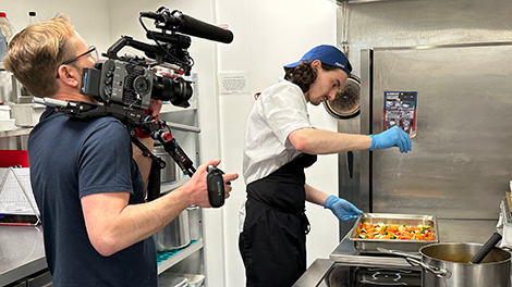 Camera operator filming a chef cooking